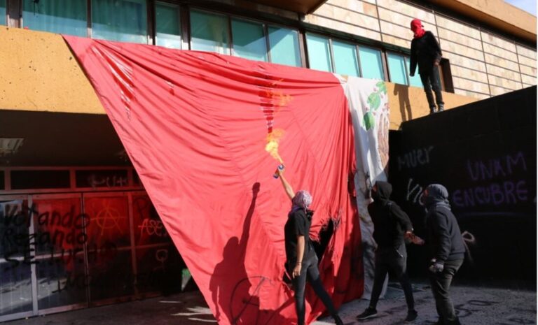 Encapuchados vandalizan UNAM y queman bandera de México